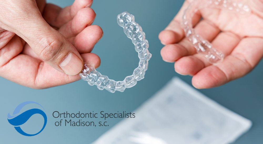 hands holding clear aligners